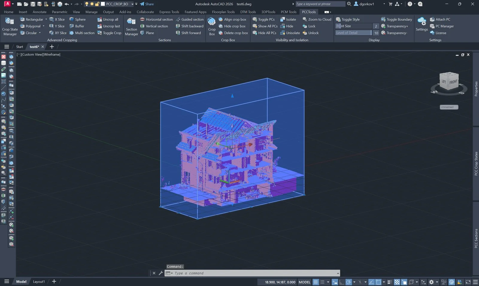 A transparent PCCTools crop box with face grips around a scanned building in AutoCAD